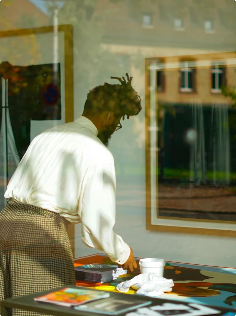 Institution staff reviewing artworks on a table